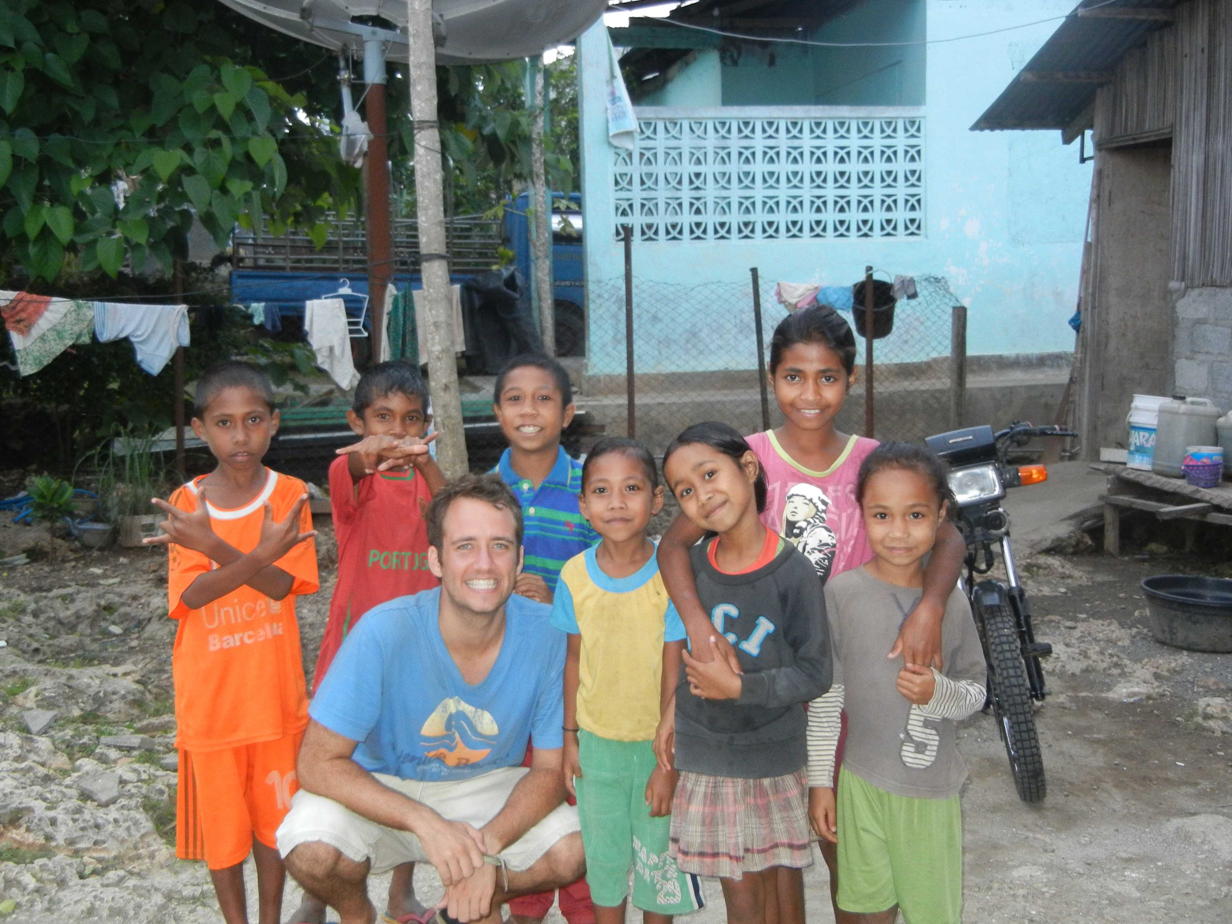 Palms Australia volunteer Heath Thompson with local kids in Timor-Leste