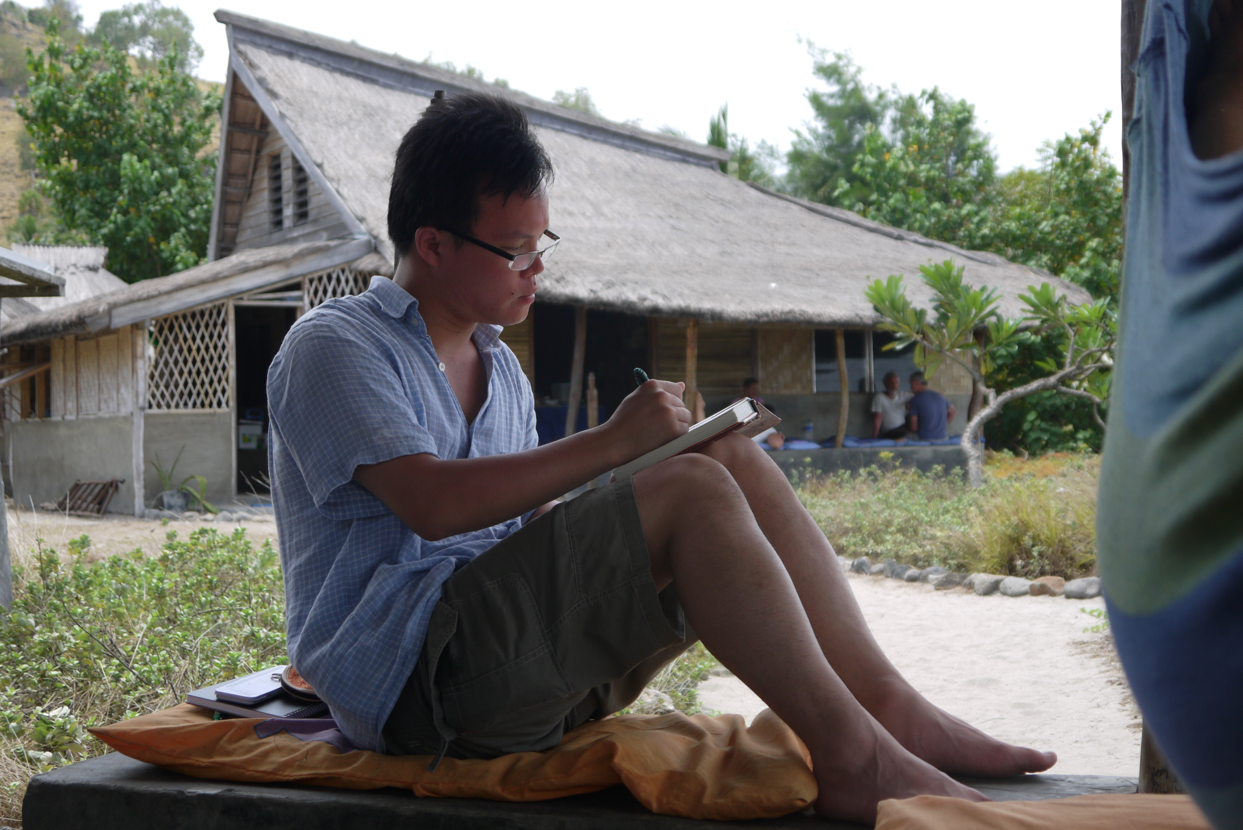 Palms Encounter participant Lawrence journaling on Atauro Island
