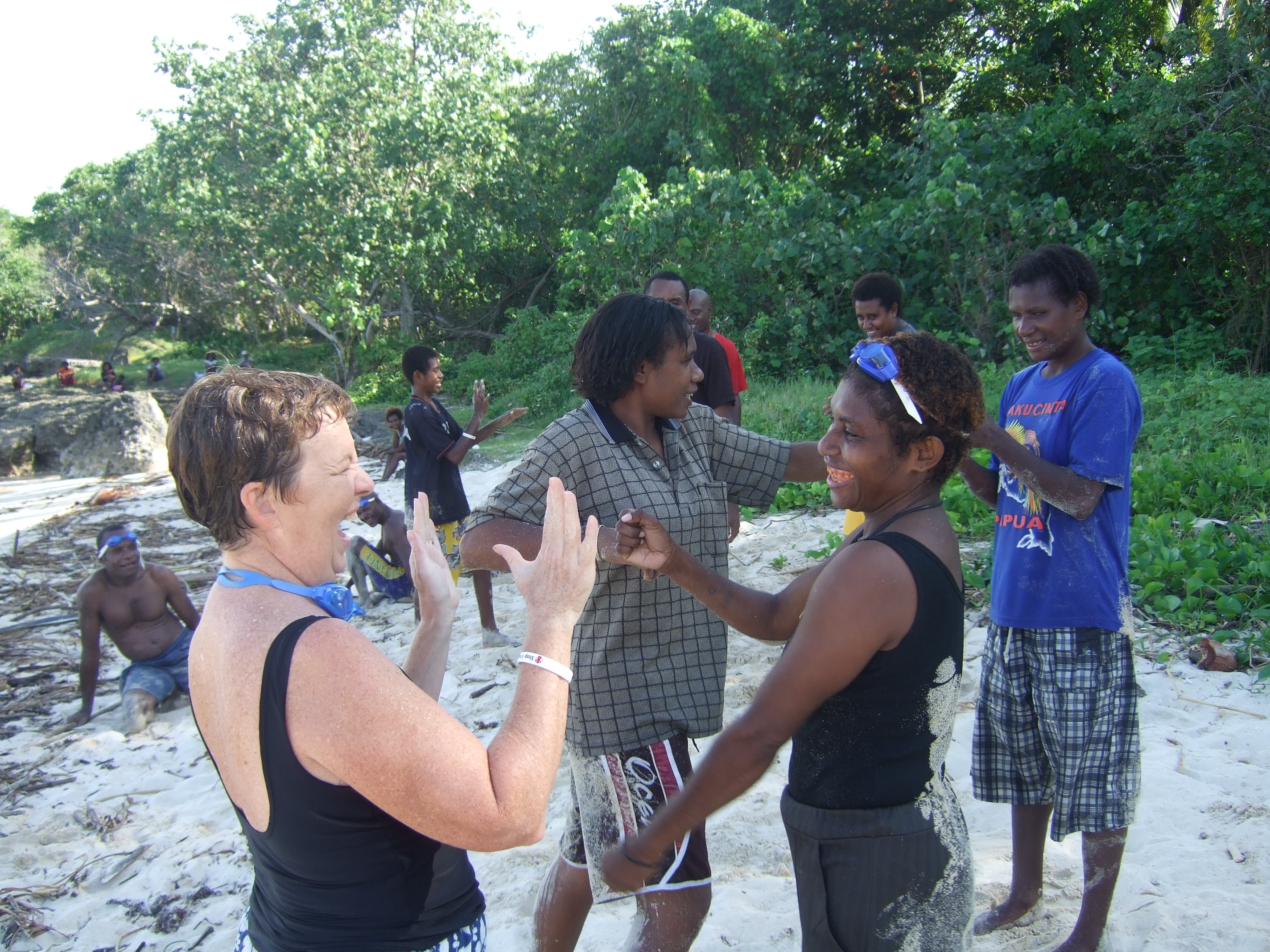 Palms Australia volunteer Helen Wolhunter with students on a beach in Papua New Guinea