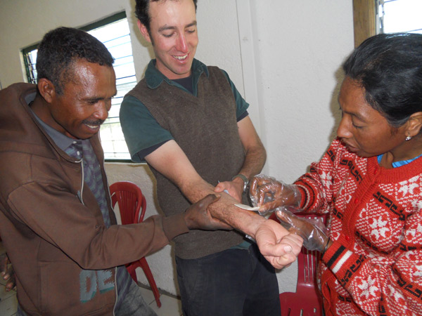 Timorese health training participants practice treating an arm wound using equipment in their new kits