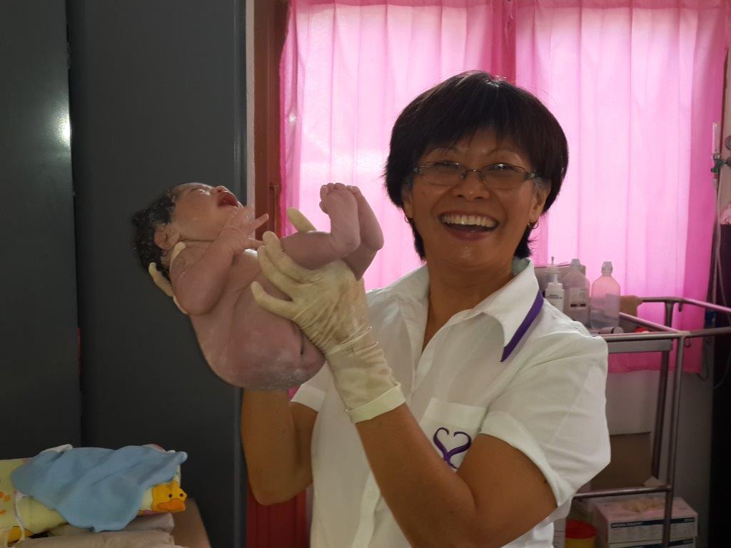 Mary Seong holding newborn baby