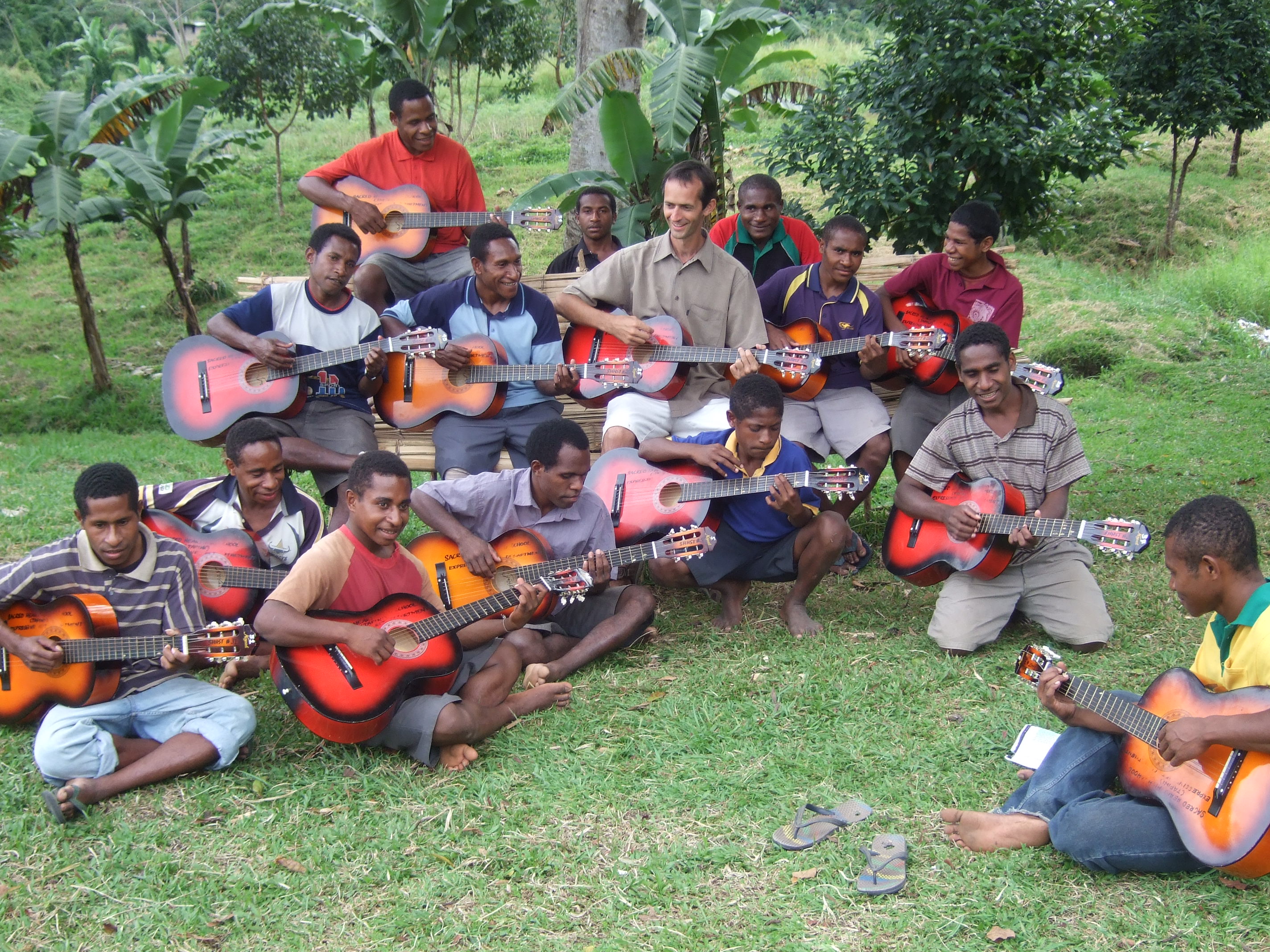 Tony and students playing guitars in Papua New Guinea