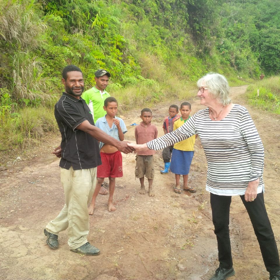 Norelle Hartwig shaking hands with a local man in Mount Hagen