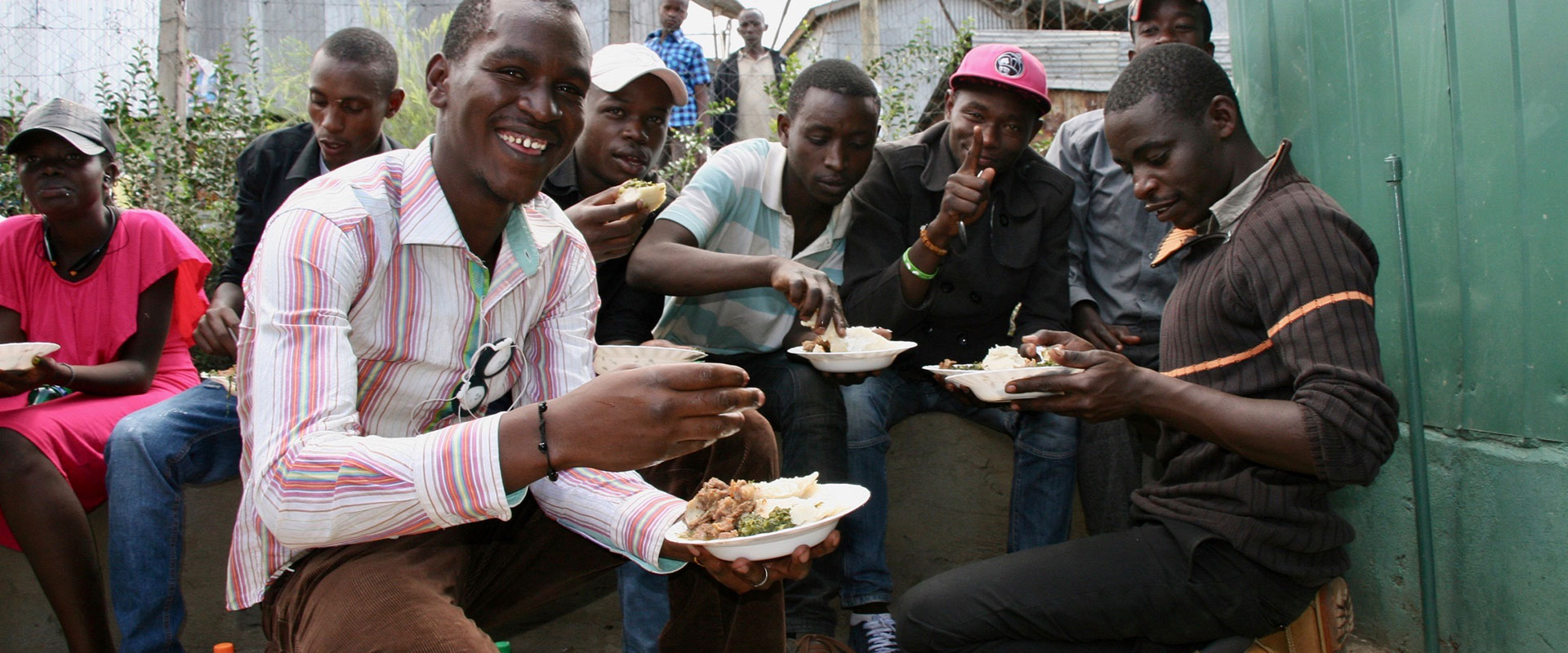 Men enjoying lunch in Mukuru, Kenya.