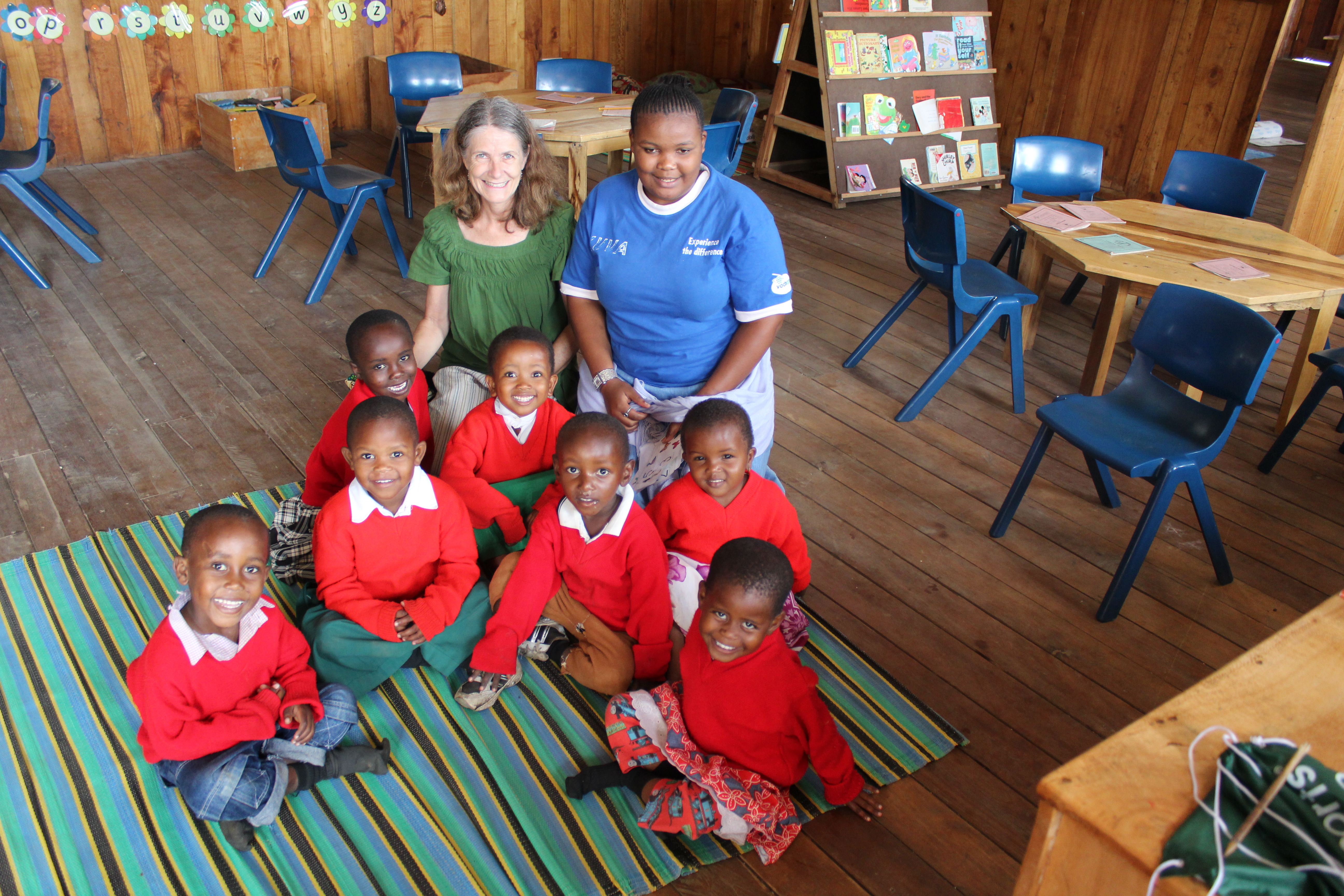 Volunteer teacher and her local counterpart with her young students in Kenya