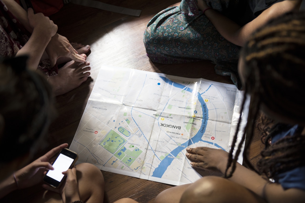 Travellers leaning over a map of Bangkok
