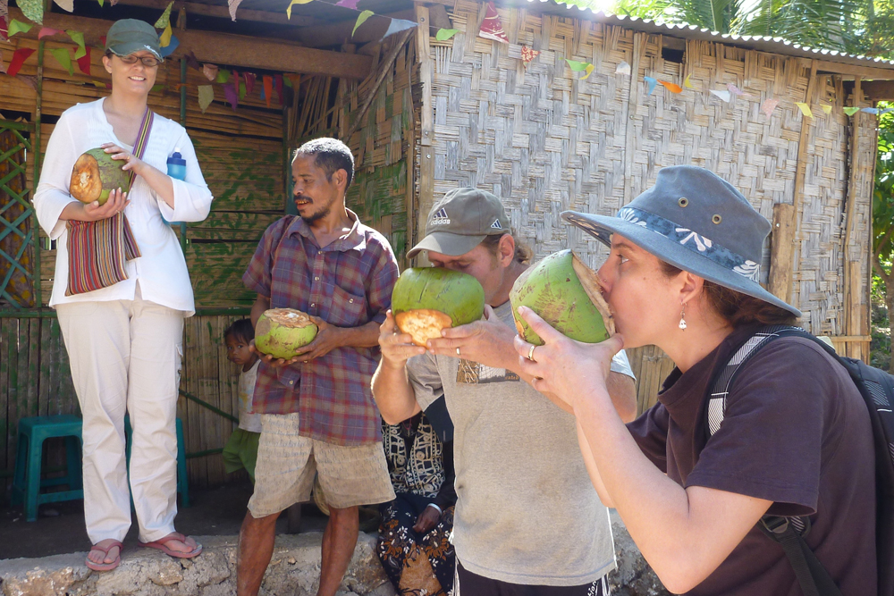 Palms Encounter participants drinking from coconuts in Timor-Leste